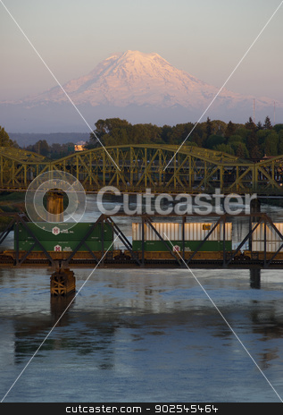 To use this stock image in your creative project, please select the size you need over to the right and click the "Add to Cart" button.
Your downloaded image will come with the Cutcaster watermark removed so don’t worry about the watermark you see on this page. Railroad and Road Bridges over Puyallup River Mt. Rainier Washin stock photo, The Puyallup River meanders down from the glaciers on Mount Rainier under bridges through cities on it's way to Puget Sound by Christopher Boswell