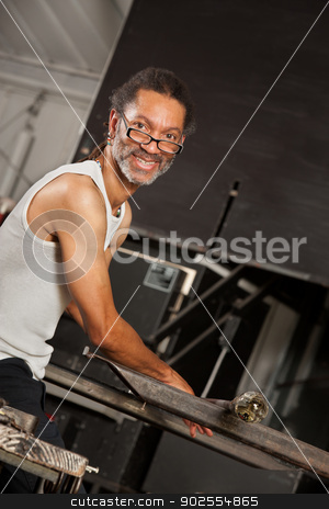 To use this stock image in your creative project, please select the size you need over to the right and click the "Add to Cart" button.
Your downloaded image will come with the Cutcaster watermark removed so don’t worry about the watermark you see on this page. Smiling Glass Art Worker stock photo, Confident Black glass artisan working on metal workbench by Scott Griessel
