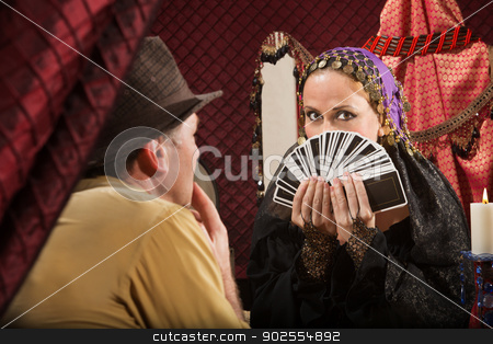 To use this stock image in your creative project, please select the size you need over to the right and click the "Add to Cart" button.
Your downloaded image will come with the Cutcaster watermark removed so don’t worry about the watermark you see on this page. Customer Chooses a Tarot Card stock photo, Attractive gypsy fortune partially covered by tarot cards by Scott Griessel