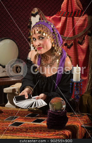 To use this stock image in your creative project, please select the size you need over to the right and click the "Add to Cart" button.
Your downloaded image will come with the Cutcaster watermark removed so don’t worry about the watermark you see on this page. Pretty Roma Fortune Teller stock photo, Beautiful Roma woman with crystal ball and tarot cards by Scott Griessel
