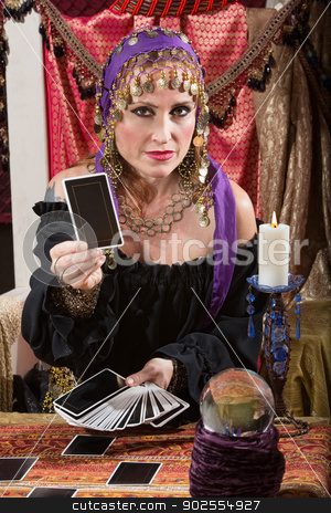 To use this stock image in your creative project, please select the size you need over to the right and click the "Add to Cart" button.
Your downloaded image will come with the Cutcaster watermark removed so don’t worry about the watermark you see on this page. Woman Dealing Tarot Cards stock photo, Pretty Romani woman dealing blank tarot cards by Scott Griessel