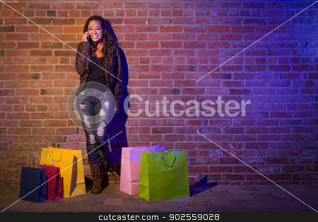 To use this stock image in your creative project, please select the size you need over to the right and click the "Add to Cart" button.
Your downloaded image will come with the Cutcaster watermark removed so don’t worry about the watermark you see on this page. Woman with Shopping Bags Using Cell Phone Against Brick Wall stock photo, Pretty Mixed Race Young Adult Woman with Shopping Bags Using Her Cell Phone Against a Brick Wall - Plenty of Copy Space. by Andy Dean