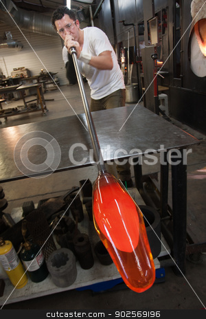 To use this stock image in your creative project, please select the size you need over to the right and click the "Add to Cart" button.
Your downloaded image will come with the Cutcaster watermark removed so don’t worry about the watermark you see on this page. Man Blowing into Glass Object stock photo, Latino artist blowing into tube with molten glass object by Scott Griessel