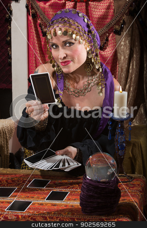 To use this stock image in your creative project, please select the size you need over to the right and click the "Add to Cart" button.
Your downloaded image will come with the Cutcaster watermark removed so don’t worry about the watermark you see on this page. Fortune Teller Dealing Tarot Cards stock photo, Pretty female gypsy fortune teller with tarot cards by Scott Griessel