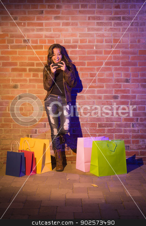 To use this stock image in your creative project, please select the size you need over to the right and click the "Add to Cart" button.
Your downloaded image will come with the Cutcaster watermark removed so don’t worry about the watermark you see on this page. Woman with Shopping Bags Using Cell Phone Against Brick Wall stock photo, Pretty Mixed Race Young Adult Woman with Shopping Bags Using Her Cell Phone Against a Brick Wall - Plenty of Copy Space. by Andy Dean
