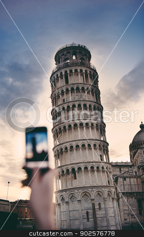 To use this stock image in your creative project, please select the size you need over to the right and click the "Add to Cart" button.
Your downloaded image will come with the Cutcaster watermark removed so don’t worry about the watermark you see on this page. Tourist taking a photo at the Pisa Tower stock photo, Tourist takes snapshots with smartphone digital camera of Pisa Tower at the entrance to Piazza dei Miracoli on a cold summer evening. by ifeelstock