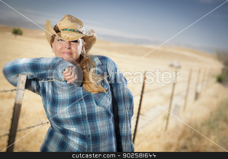 To use this stock image in your creative project, please select the size you need over to the right and click the "Add to Cart" button.
Your downloaded image will come with the Cutcaster watermark removed so don’t worry about the watermark you see on this page. Beautiful Cowgirl Against Wire Fence in Field stock photo, Beautiful Cowgirl Against Barbed Wire Fence in Field. by Andy Dean