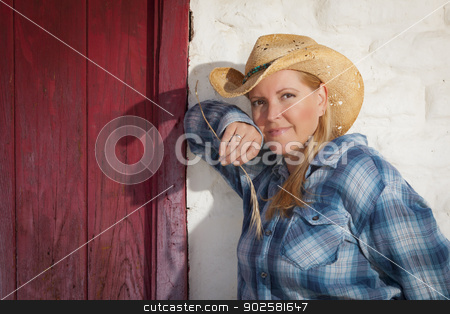 To use this stock image in your creative project, please select the size you need over to the right and click the "Add to Cart" button.
Your downloaded image will come with the Cutcaster watermark removed so don’t worry about the watermark you see on this page. Beautiful Cowgirl Against Old Wall and Red Door stock photo, Beautiful Cowgirl Wearing Cowboy Hat Leaning Against Old Adobe Wall and Red Door. by Andy Dean