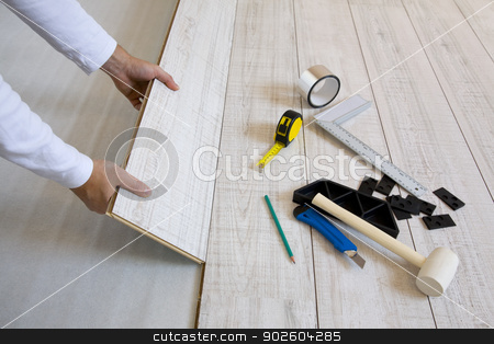 To use this stock image in your creative project, please select the size you need over to the right and click the "Add to Cart" button.
Your downloaded image will come with the Cutcaster watermark removed so don’t worry about the watermark you see on this page. Worker laying laminated stock photo, Worker laying a floor with laminated flooring boards by Tilo