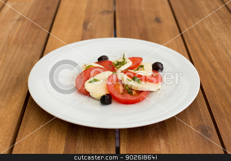 To use this stock image in your creative project, please select the size you need over to the right and click the "Add to Cart" button.
Your downloaded image will come with the Cutcaster watermark removed so don’t worry about the watermark you see on this page. Fresh mozzarella, tomatoes salad stock photo, Fresh mozzarella, tomatoes salad in white plate on a wooden table. by doupix