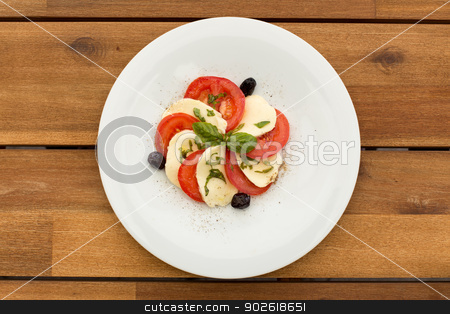 To use this stock image in your creative project, please select the size you need over to the right and click the "Add to Cart" button.
Your downloaded image will come with the Cutcaster watermark removed so don’t worry about the watermark you see on this page. Tomatoes and mozzarella salad stock photo, Tomatoes and mozzarella salad in white plate on a wooden table. by doupix