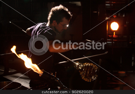 To use this stock image in your creative project, please select the size you need over to the right and click the "Add to Cart" button.
Your downloaded image will come with the Cutcaster watermark removed so don’t worry about the watermark you see on this page. Glass Worker Near Blast Furnace stock photo, Glass worker near blast furnace and blowtorch by Scott Griessel