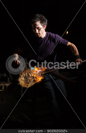 To use this stock image in your creative project, please select the size you need over to the right and click the "Add to Cart" button.
Your downloaded image will come with the Cutcaster watermark removed so don’t worry about the watermark you see on this page. Blowtorch on Glass Object stock photo, Glass craftsman using blowtorch to shape a jar by Scott Griessel
