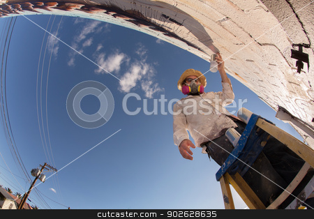 To use this stock image in your creative project, please select the size you need over to the right and click the "Add to Cart" button.
Your downloaded image will come with the Cutcaster watermark removed so don’t worry about the watermark you see on this page. Wide Angle View of Graffit Artist stock photo, Wide angle view of disguised graffiti artist working on mural by Scott Griessel