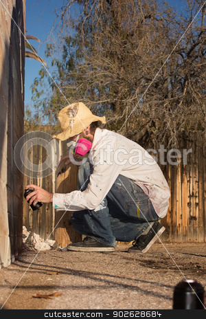 To use this stock image in your creative project, please select the size you need over to the right and click the "Add to Cart" button.
Your downloaded image will come with the Cutcaster watermark removed so don’t worry about the watermark you see on this page. Crouching Man Spray Painting stock photo, Man crouching on the ground using spray paint on a wall by Scott Griessel