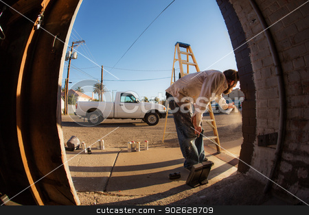 To use this stock image in your creative project, please select the size you need over to the right and click the "Add to Cart" button.
Your downloaded image will come with the Cutcaster watermark removed so don’t worry about the watermark you see on this page. Male Graffiti Artist with Spray Cans stock photo, Wide angle view of man with spray paint cans and ladder by Scott Griessel