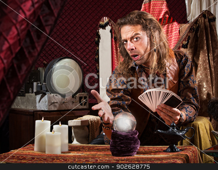 To use this stock image in your creative project, please select the size you need over to the right and click the "Add to Cart" button.
Your downloaded image will come with the Cutcaster watermark removed so don’t worry about the watermark you see on this page. Enticing Fortune Teller stock photo, Enticing man with tarot cards and crystal ball by Scott Griessel