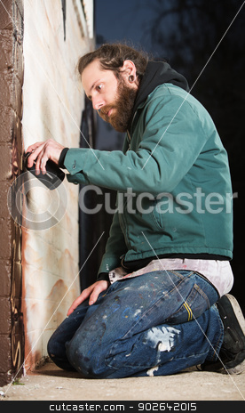 To use this stock image in your creative project, please select the size you need over to the right and click the "Add to Cart" button.
Your downloaded image will come with the Cutcaster watermark removed so don’t worry about the watermark you see on this page. Kneeling Man Spray Painting stock photo, Man kneeling on the ground while spray painting a wall by Scott Griessel