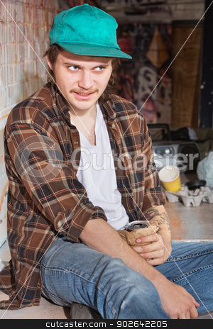 To use this stock image in your creative project, please select the size you need over to the right and click the "Add to Cart" button.
Your downloaded image will come with the Cutcaster watermark removed so don’t worry about the watermark you see on this page. Teen with Beer stock photo, Strange looking teenage male holding beer in brown bag by Scott Griessel