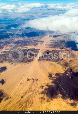 To use this stock image in your creative project, please select the size you need over to the right and click the "Add to Cart" button.
Your downloaded image will come with the Cutcaster watermark removed so don’t worry about the watermark you see on this page. View from the window of an airplane flying stock photo, Aerial view landscape near Hurgada town over clouds in Egypt by Imaster