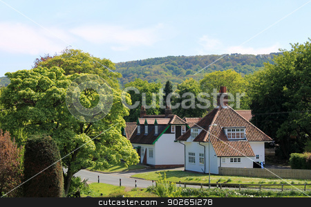 To use this stock image in your creative project, please select the size you need over to the right and click the "Add to Cart" button.
Your downloaded image will come with the Cutcaster watermark removed so don’t worry about the watermark you see on this page. English village stock photo, Scenic view of green houses in green countryside, England. by Martin Crowdy
