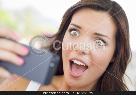 To use this stock image in your creative project, please select the size you need over to the right and click the "Add to Cart" button.
Your downloaded image will come with the Cutcaster watermark removed so don’t worry about the watermark you see on this page. Shocked Young Adult Female Reading Cell Phone Outdoors stock photo, Shocked Young Adult Female Reading Cell Phone Outdoors on Bench. by Andy Dean