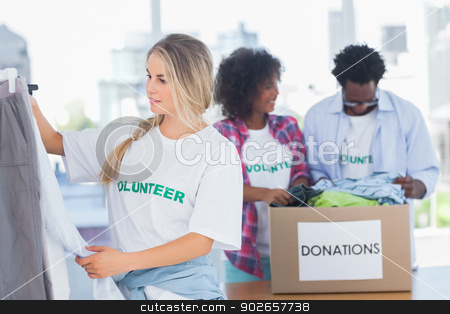 To use this stock image in your creative project, please select the size you need over to the right and click the "Add to Cart" button.
Your downloaded image will come with the Cutcaster watermark removed so don’t worry about the watermark you see on this page. Volunteers putting clothes in clothes rail stock photo, Volunteers putting clothes in clothes rail in their office by Wavebreak Media
