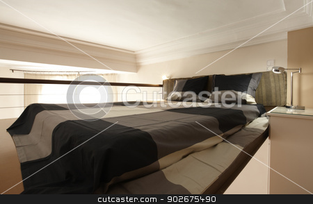 To use this stock image in your creative project, please select the size you need over to the right and click the "Add to Cart" button.
Your downloaded image will come with the Cutcaster watermark removed so don’t worry about the watermark you see on this page. modern bedroom stock photo, A modern bedroom in an overhead attic by ABBPhoto