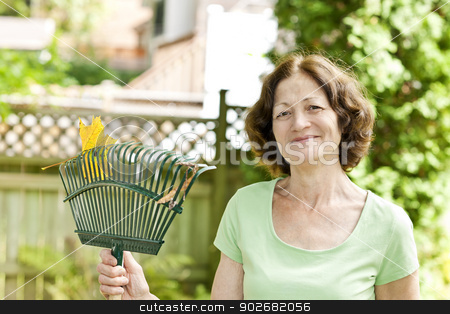 To use this stock image in your creative project, please select the size you need over to the right and click the "Add to Cart" button.
Your downloaded image will come with the Cutcaster watermark removed so don’t worry about the watermark you see on this page. Senior woman holding rake stock photo, Senior woman smiling holding rake for yard work outside by Elena Elisseeva