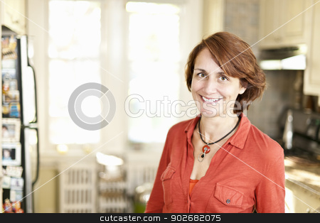 To use this stock image in your creative project, please select the size you need over to the right and click the "Add to Cart" button.
Your downloaded image will come with the Cutcaster watermark removed so don’t worry about the watermark you see on this page. Happy woman in kitchen at home stock photo, Portrait of smiling mature woman in kitchen at home by Elena Elisseeva
