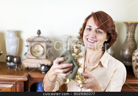 To use this stock image in your creative project, please select the size you need over to the right and click the "Add to Cart" button.
Your downloaded image will come with the Cutcaster watermark removed so don’t worry about the watermark you see on this page. Woman polishing antiques stock photo, Happy caucasian woman proudly polishing antique collection by Elena Elisseeva
