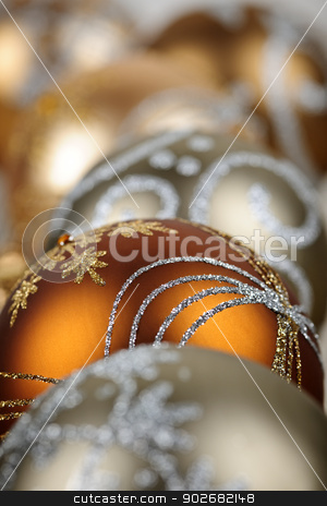 To use this stock image in your creative project, please select the size you need over to the right and click the "Add to Cart" button.
Your downloaded image will come with the Cutcaster watermark removed so don’t worry about the watermark you see on this page. Gold Christmas ornaments closeup stock photo, Closeup of golden Christmas balls with festive designs by Elena Elisseeva