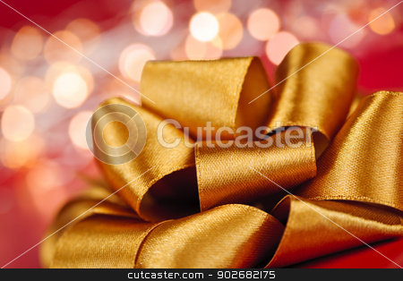 To use this stock image in your creative project, please select the size you need over to the right and click the "Add to Cart" button.
Your downloaded image will come with the Cutcaster watermark removed so don’t worry about the watermark you see on this page. Gold gift bow with festive lights stock photo, Golden ribbon gift bow closeup with festive lights by Elena Elisseeva