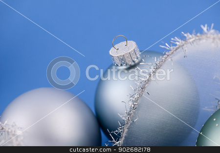 To use this stock image in your creative project, please select the size you need over to the right and click the "Add to Cart" button.
Your downloaded image will come with the Cutcaster watermark removed so don’t worry about the watermark you see on this page. Christmas baubles on blue stock photo, Glass Christmas balls with holiday ribbon on blue background by Elena Elisseeva