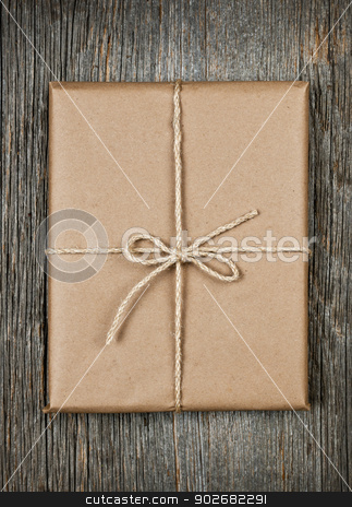 To use this stock image in your creative project, please select the size you need over to the right and click the "Add to Cart" button.
Your downloaded image will come with the Cutcaster watermark removed so don’t worry about the watermark you see on this page. Gift in brown paper tied with string stock photo, Gift package in brown paper wrapper tied with string on rustic wood background by Elena Elisseeva