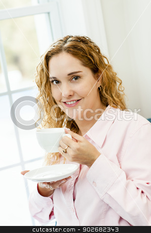 To use this stock image in your creative project, please select the size you need over to the right and click the "Add to Cart" button.
Your downloaded image will come with the Cutcaster watermark removed so don’t worry about the watermark you see on this page. Woman relaxing by the window with beverage stock photo, Smiling caucasian woman relaxing by window holding cup of coffee by Elena Elisseeva