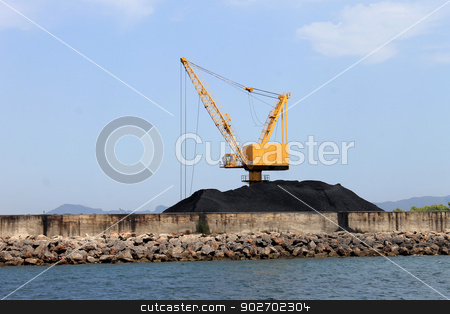 To use this stock image in your creative project, please select the size you need over to the right and click the "Add to Cart" button.
Your downloaded image will come with the Cutcaster watermark removed so don’t worry about the watermark you see on this page. Crane and pile of coal on docks stock photo, Scenic view of yellow industrial crane and pile of coal on docks, Alcudia harbor, Majorca, Spain. by Martin Crowdy