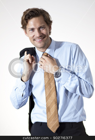 To use this stock image in your creative project, please select the size you need over to the right and click the "Add to Cart" button.
Your downloaded image will come with the Cutcaster watermark removed so don’t worry about the watermark you see on this page. Smiling businessman casual looking stock photo, Smiling casual businessman correcting his tie by Thomas Rugdal