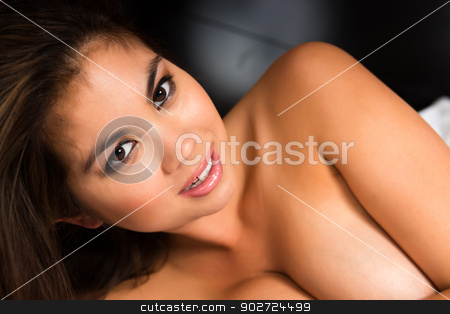 To use this stock image in your creative project, please select the size you need over to the right and click the "Add to Cart" button.
Your downloaded image will come with the Cutcaster watermark removed so don’t worry about the watermark you see on this page. Eurasian stock photo, Beautiful young Eurasian woman lying in bed by Harris Shiffman