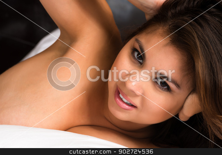 To use this stock image in your creative project, please select the size you need over to the right and click the "Add to Cart" button.
Your downloaded image will come with the Cutcaster watermark removed so don’t worry about the watermark you see on this page. Eurasian stock photo, Beautiful young Eurasian woman lying in bed by Harris Shiffman
