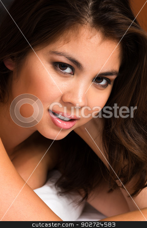 To use this stock image in your creative project, please select the size you need over to the right and click the "Add to Cart" button.
Your downloaded image will come with the Cutcaster watermark removed so don’t worry about the watermark you see on this page. Eurasian stock photo, Beautiful young Eurasian woman lying in bed by Harris Shiffman