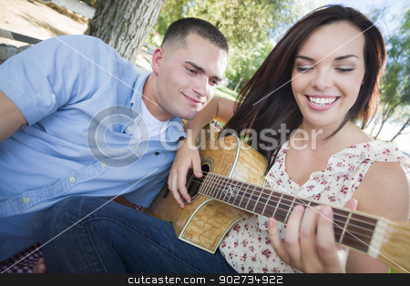 To use this stock image in your creative project, please select the size you need over to the right and click the "Add to Cart" button.
Your downloaded image will come with the Cutcaster watermark removed so don’t worry about the watermark you see on this page. Mixed Race Couple at the Park Playing Guitar and Singing stock photo, Happy Mixed Race Couple at the Park Playing Guitar and Singing Songs. by Andy Dean