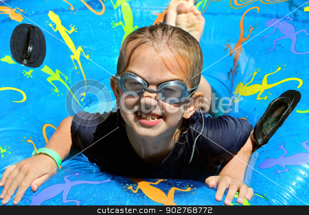 To use this stock image in your creative project, please select the size you need over to the right and click the "Add to Cart" button.
Your downloaded image will come with the Cutcaster watermark removed so don’t worry about the watermark you see on this page. Girl playing in swimming pool stock photo, Cute girl playing on inflatable in swimming pool. by Martin Crowdy