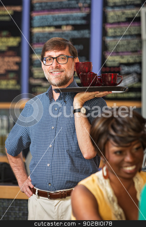 To use this stock image in your creative project, please select the size you need over to the right and click the "Add to Cart" button.
Your downloaded image will come with the Cutcaster watermark removed so don’t worry about the watermark you see on this page. Barista Serving Drinks stock photo, Man with glasses serving drinks to customers by Scott Griessel