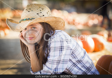 To use this stock image in your creative project, please select the size you need over to the right and click the "Add to Cart" button.
Your downloaded image will come with the Cutcaster watermark removed so don’t worry about the watermark you see on this page. Preteen Girl Portrait at the Pumpkin Patch stock photo, Preteen Girl Wearing Cowboy Hat Portrait at the Pumpkin Patch in a Rustic Setting. by Andy Dean