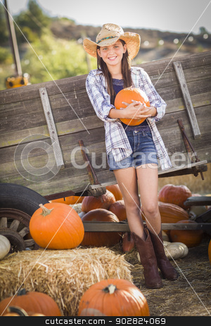 To use this stock image in your creative project, please select the size you need over to the right and click the "Add to Cart" button.
Your downloaded image will come with the Cutcaster watermark removed so don’t worry about the watermark you see on this page. Preteen Girl Portrait at the Pumpkin Patch stock photo, Preteen Girl Wearing Cowboy Hat Portrait at the Pumpkin Patch in a Rustic Setting. by Andy Dean