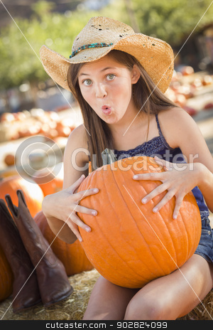 To use this stock image in your creative project, please select the size you need over to the right and click the "Add to Cart" button.
Your downloaded image will come with the Cutcaster watermark removed so don’t worry about the watermark you see on this page. Preteen Girl Holding A Large Pumpkin at the Pumpkin Patch stock photo, Preteen Girl Holding A Large Pumpkin at the Pumpkin Patch in a Rustic Setting. by Andy Dean