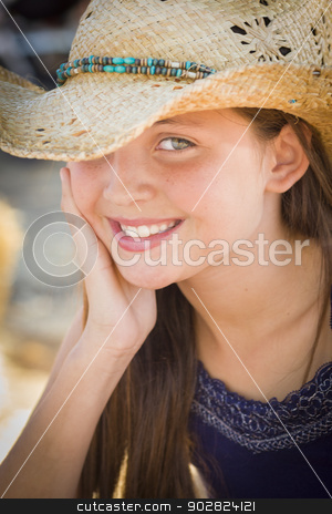 To use this stock image in your creative project, please select the size you need over to the right and click the "Add to Cart" button.
Your downloaded image will come with the Cutcaster watermark removed so don’t worry about the watermark you see on this page. Preteen Girl Portrait Wearing Cowboy Hat stock photo, Preteen Girl Portrait Wearing Cowboy Hat in Rustic Setting. by Andy Dean