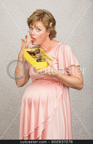 To use this stock image in your creative project, please select the size you need over to the right and click the "Add to Cart" button.
Your downloaded image will come with the Cutcaster watermark removed so don’t worry about the watermark you see on this page. Guilty Pregnant Woman Eating stock photo, Guilty pregnant woman pigging out on box of chocolates by Scott Griessel