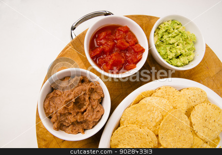 To use this stock image in your creative project, please select the size you need over to the right and click the "Add to Cart" button.
Your downloaded image will come with the Cutcaster watermark removed so don’t worry about the watermark you see on this page. Chips Salsa Refried Beans Guacamole Nachos Food Fresh Appetizer stock photo, Food Appetizers Chips and Salsa Refried Beans Guacamole on Wood Cutting Board by Christopher Boswell